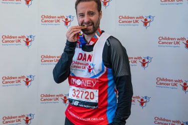 London Marathon 2021 runner biting his medal