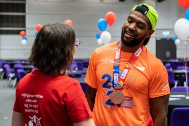 London Marathon 2021 runner wearing orange finishers top