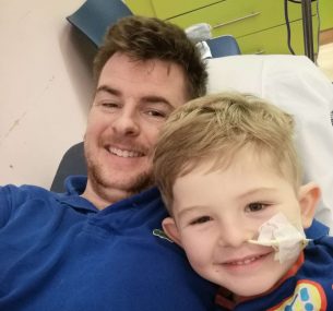 Martin with son Finley laying in hospital bed