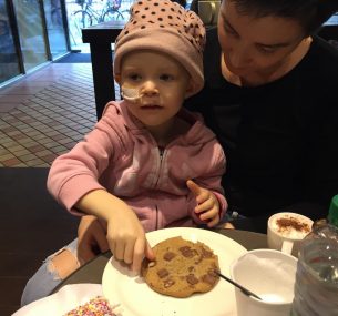 Bella Rose in hospital, eating a cookie