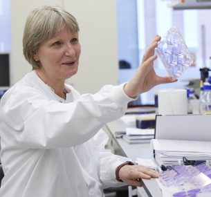 A scientists examines samples in the lab