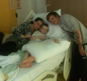 Aflie with his mum and dad in hospital
