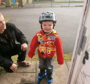 Alfie wearing skates with his dad Nathan