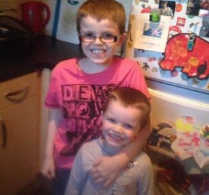 Big brother Bobby wearing glasses with Alfie