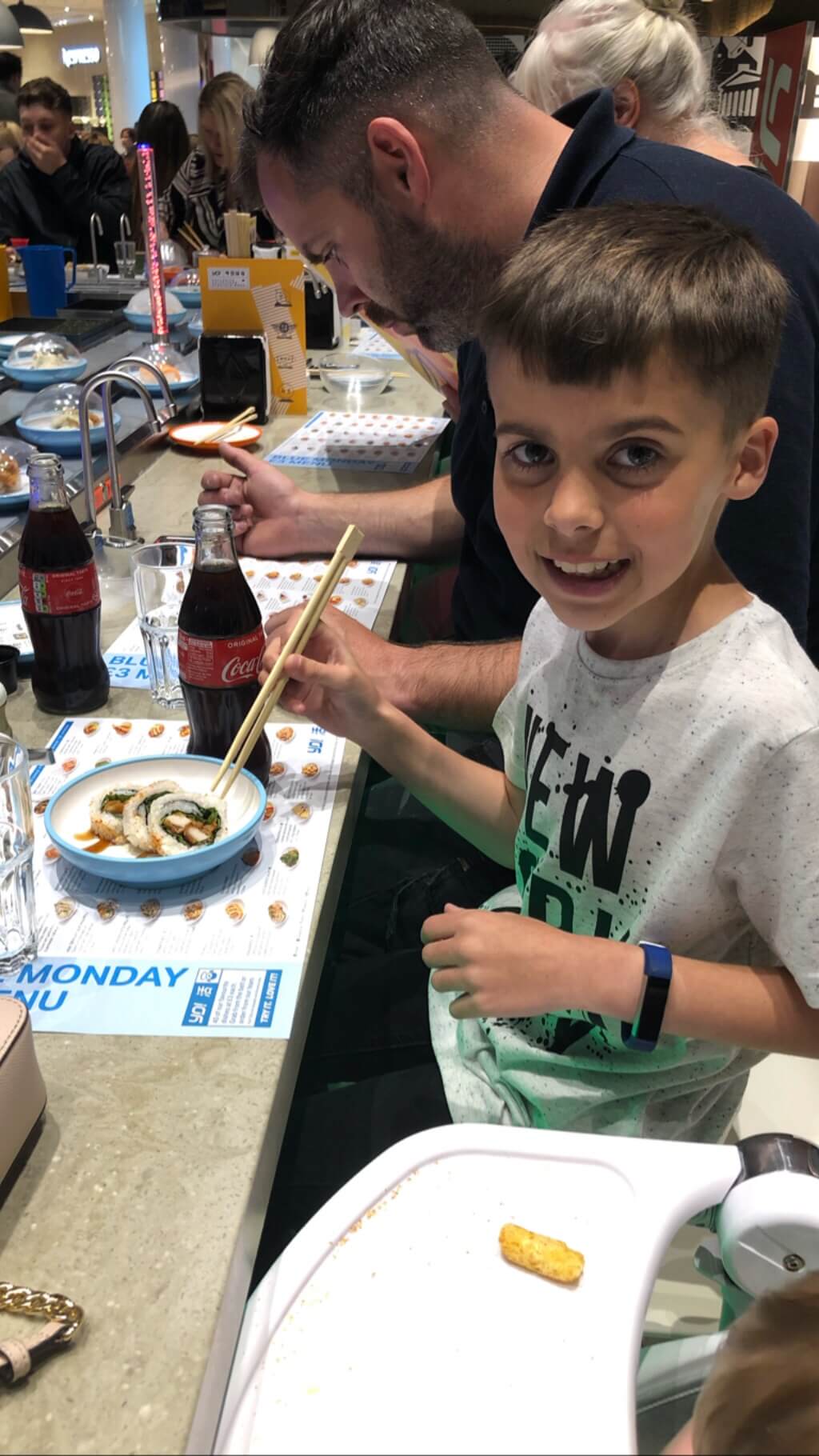 Alfie in a restaurant eating sushi