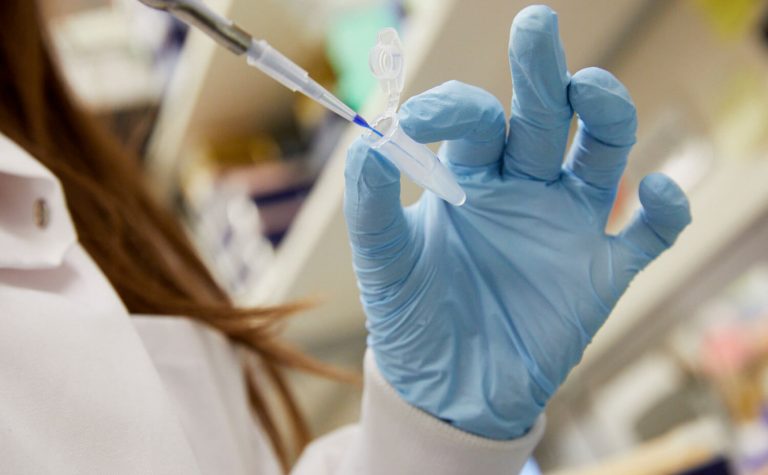 researcher hand with blue glove and syringe (1)