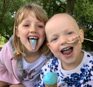 Florie with sister eating blue ice cream.