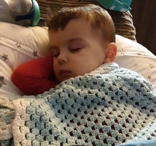 Jacob asleep under blanket