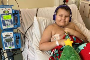 Jesse in hospital bed having a blood transfusion during Christmas