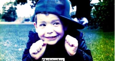 Christopher wearing hat and smiling