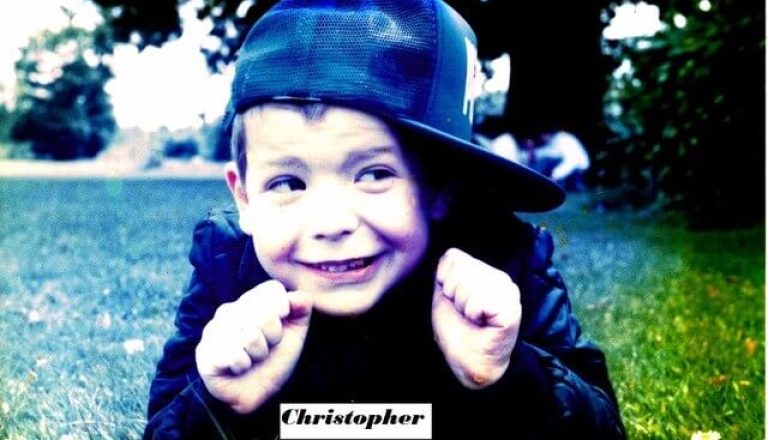 Christopher wearing hat and smiling