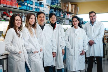 a group of researchers in white laboratory coats