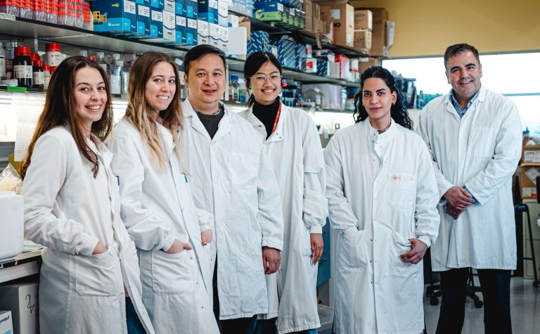 a group of researchers in white laboratory coats