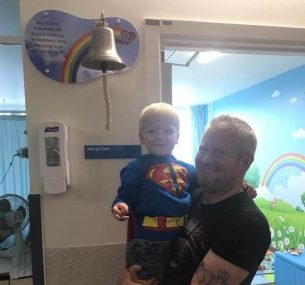 Dylan ringing bell in superman outfit