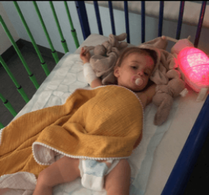 Florrie sleeping in hospital crib