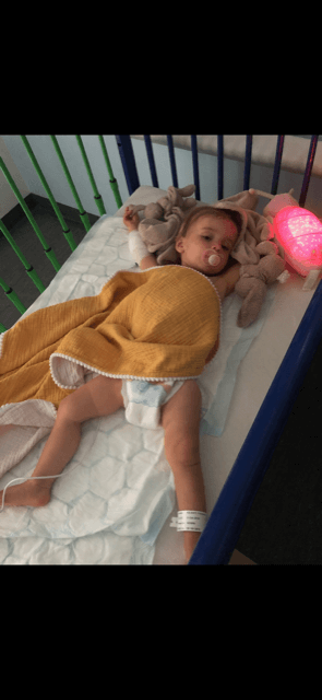 Florrie sleeping in hospital crib