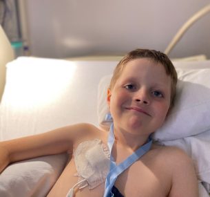 Rufus smiling at camera in hospital bed
