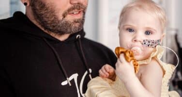 Summer with dad looking at camera with nasal tube 2