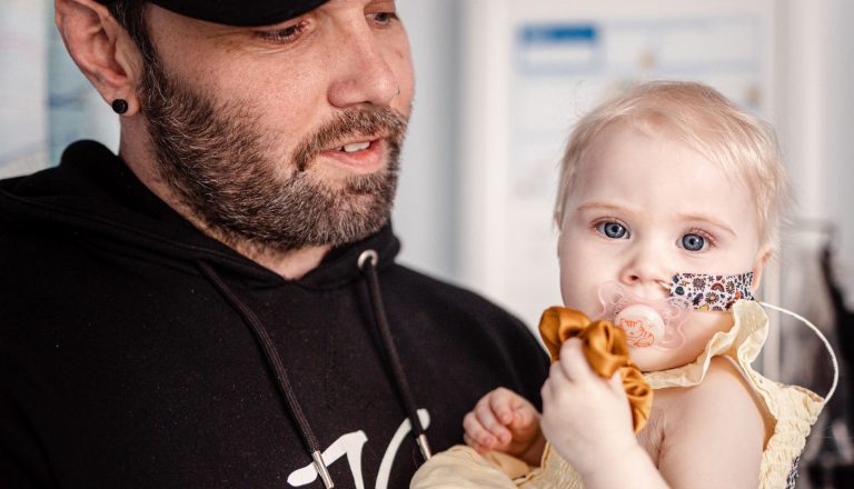 Summer with dad looking at camera with nasal tube 2