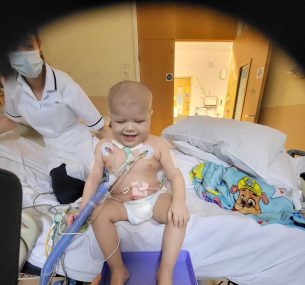 Archer in hospital bed with nurse