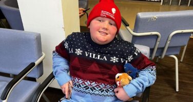 Aston in red hat during radiotherapy