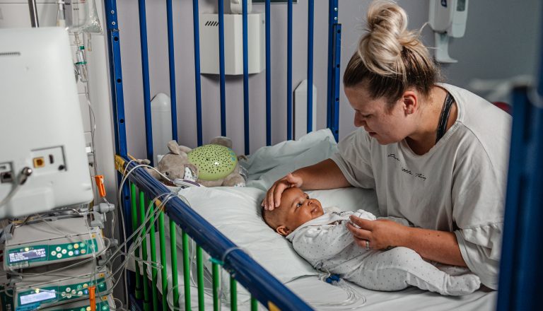 Amelia in hospital crib with mum