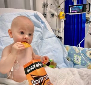Mason eating doritos in hospital bed