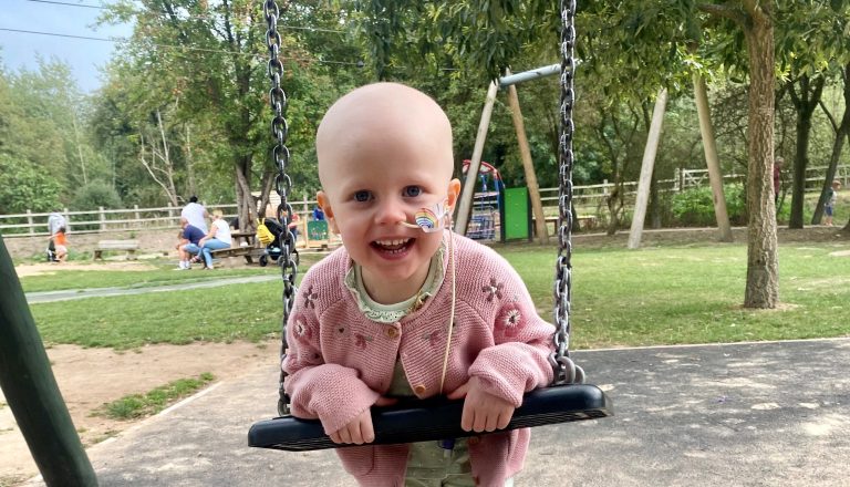 Matilda with nose tube on playground swing webpage