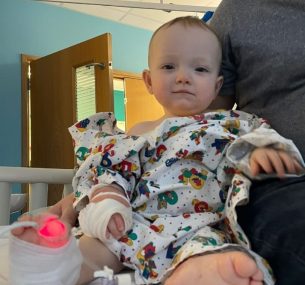 Stanley in hospital bed with tube