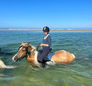 Caroline riding horse in the sea