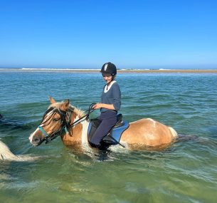 Caroline riding horse in the sea