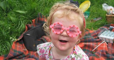 Libby as child in sunglasses
