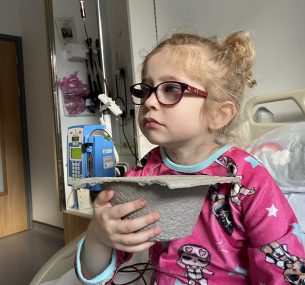 Dulcie in her pyjamas in hospital bed
