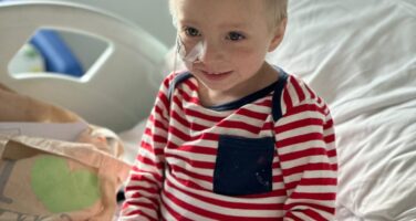 George smiling in hospital bed