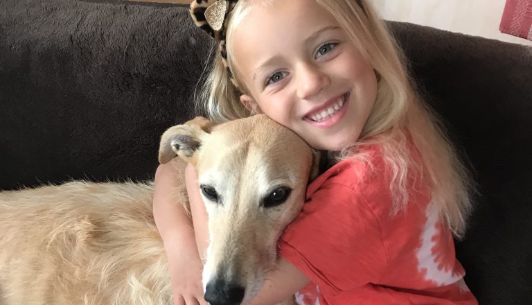 Neive smiling with dog .