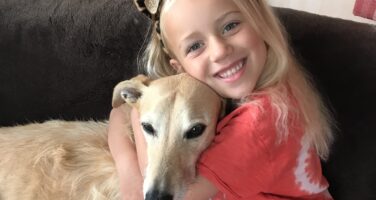Neive smiling with dog .
