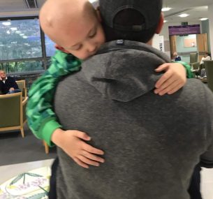 Leighton being carried by his dad