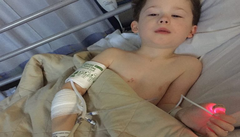 Leighton laying in his hospital bed.