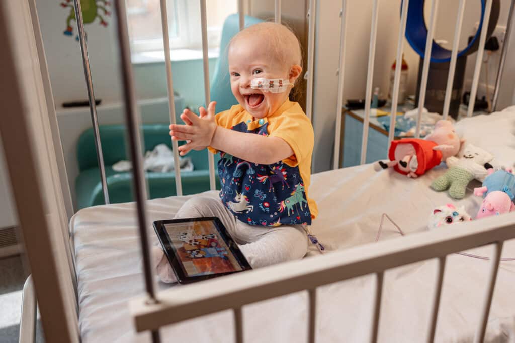 Smiley baby in hospital bed