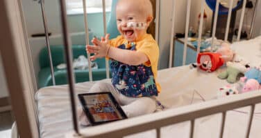 Smiley baby in hospital bed